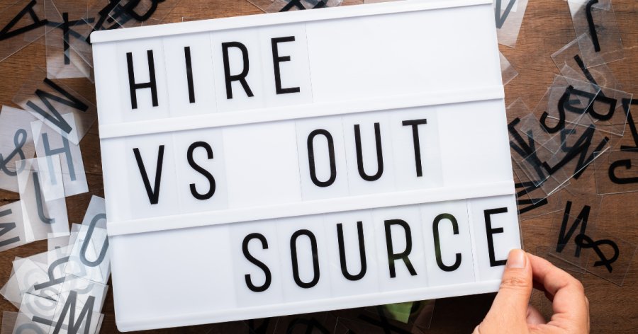 A lightbox showing the words hire or outsource